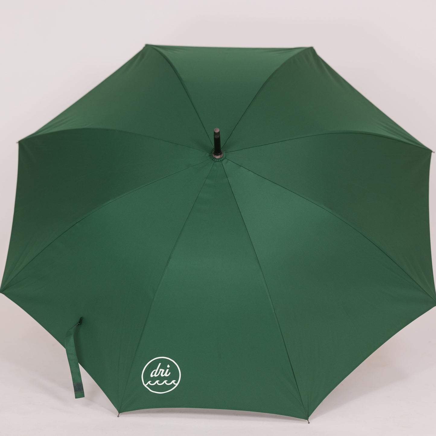 A green umbrella with a bamboo handle, used for outdoor protection against rain or sun.