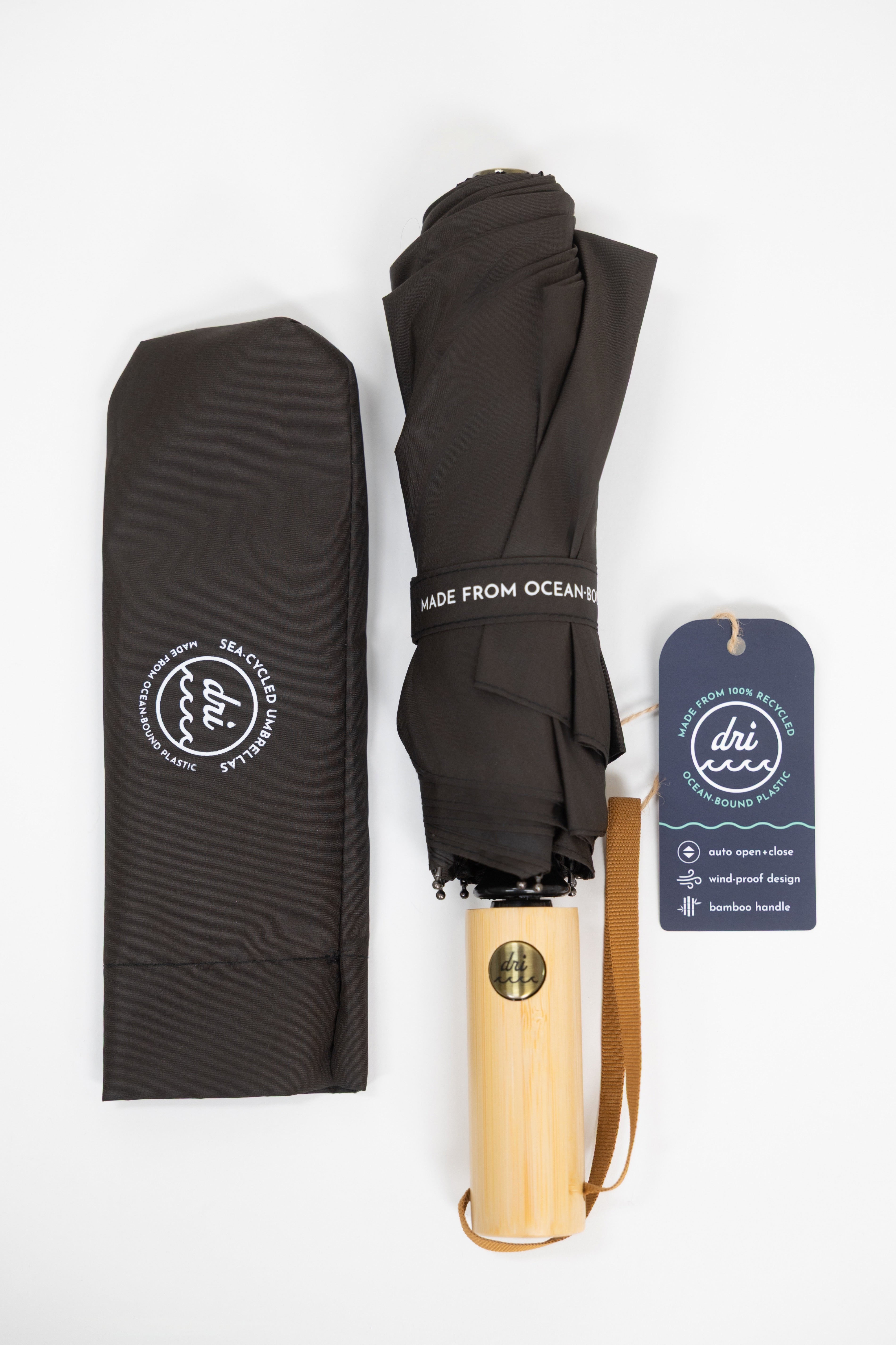 Black umbrella with bamboo handle and black carrying case on a white background