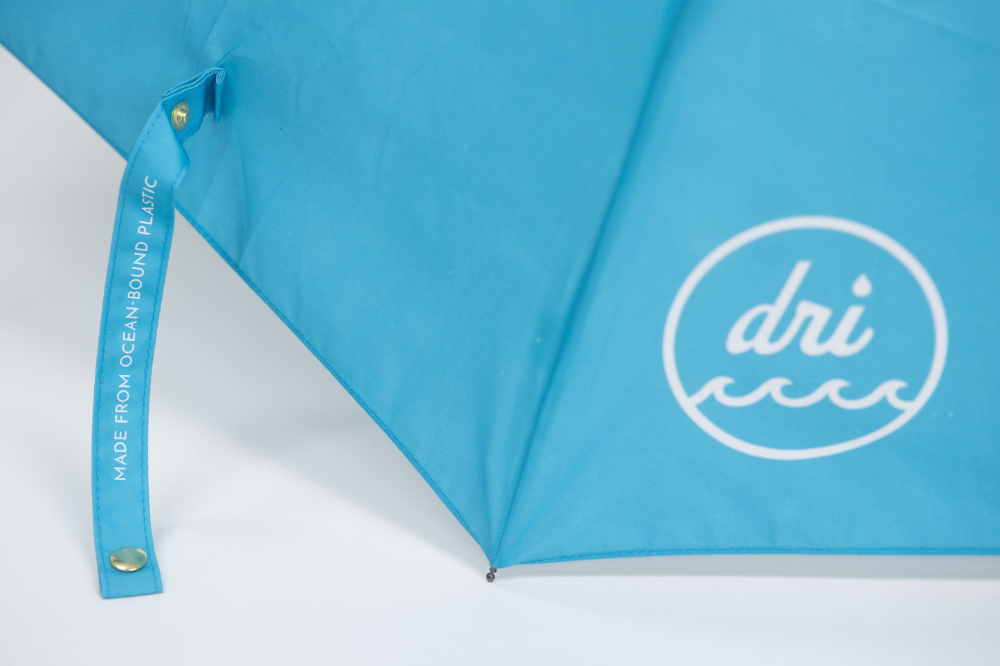 Blue umbrella with Dri logo on a white background