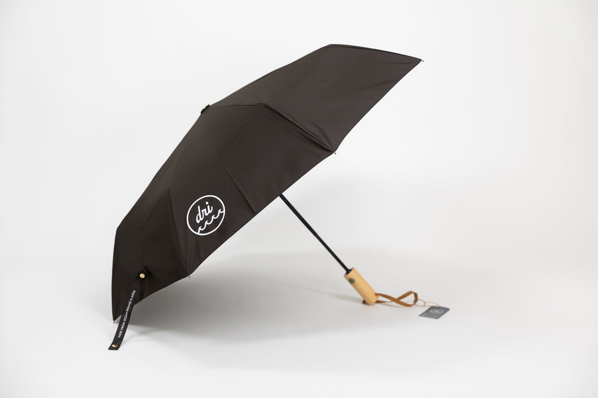 Black umbrella with a visible brand logo on a white background