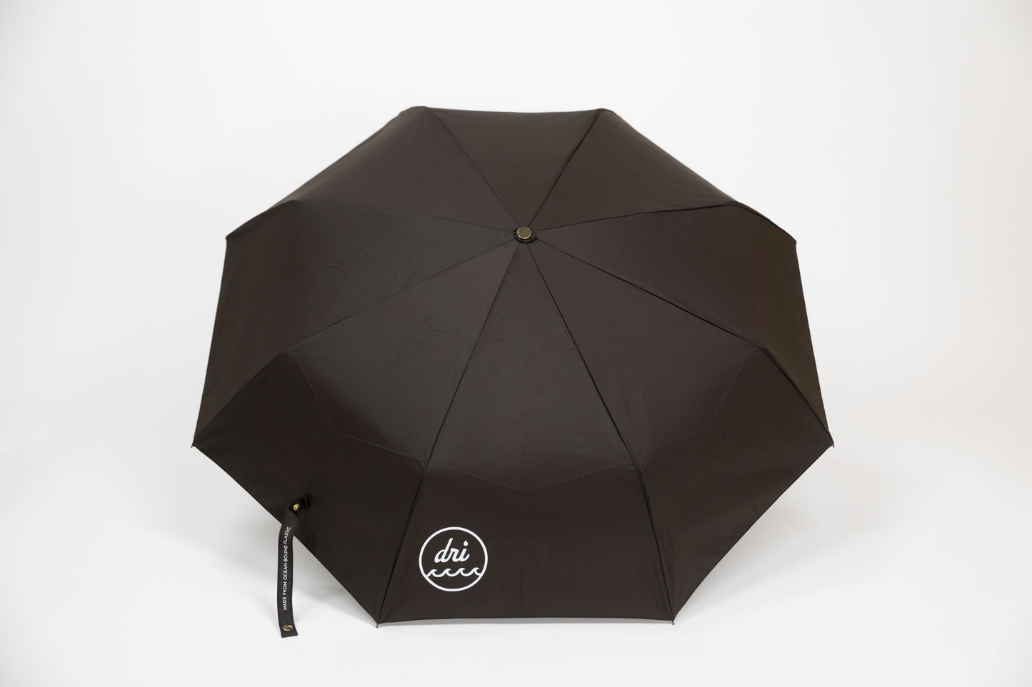 Black umbrella with 'dri ever' logo on a white background