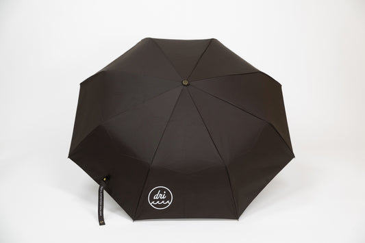 Black umbrella with 'dri ever' logo on a white background