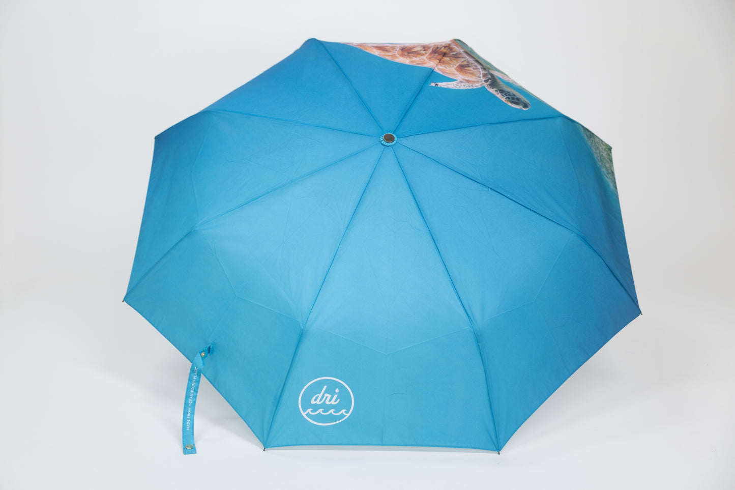 Blue umbrella with a visible brand logo on a white background